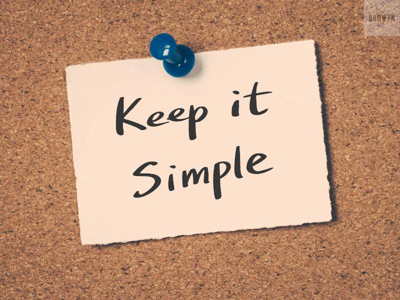 Note pinned on a corkboard with the phrase 'Keep it Simple,' emphasizing simple project management strategies for scaling a small business.