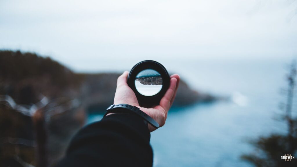 Person holding a telescope representing a choice of reality.