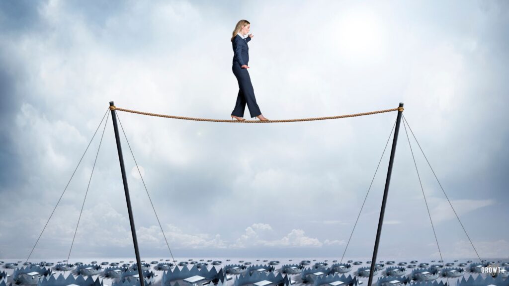 image of a woman walking on a high wire with learning trap underneath.