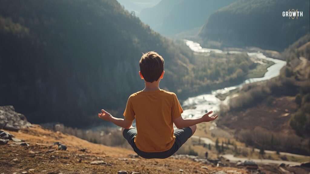 Image of the reverse angle (from the back) of young boy levitating (clearly off the even ground) while he meditates in a serne sunlit area near mountains and rivers.