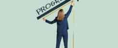 Image of a woman using a measuring tape on an arrow that is underneath the word progress written on the wall.